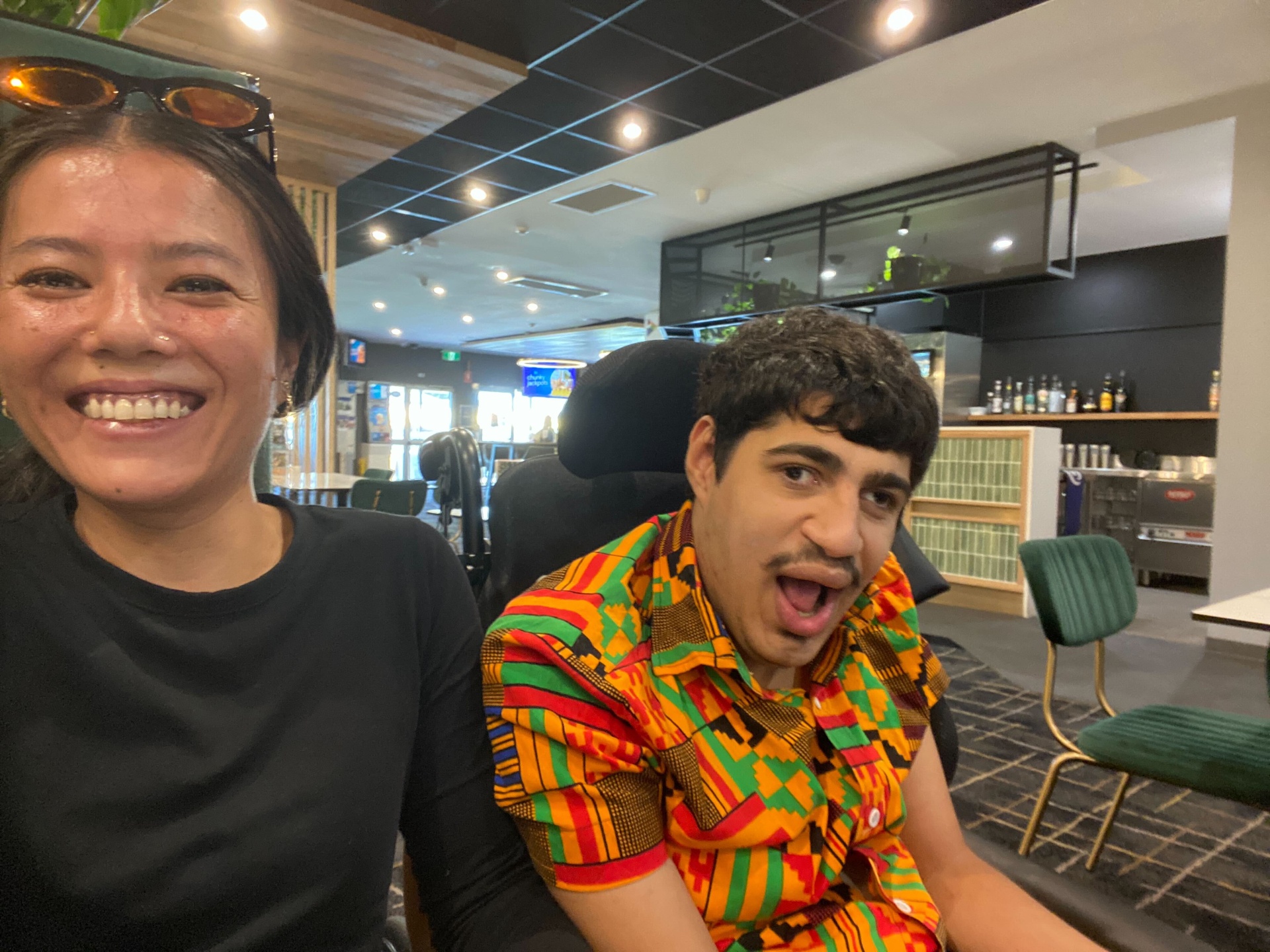 A support worker and participant sharing a laugh together