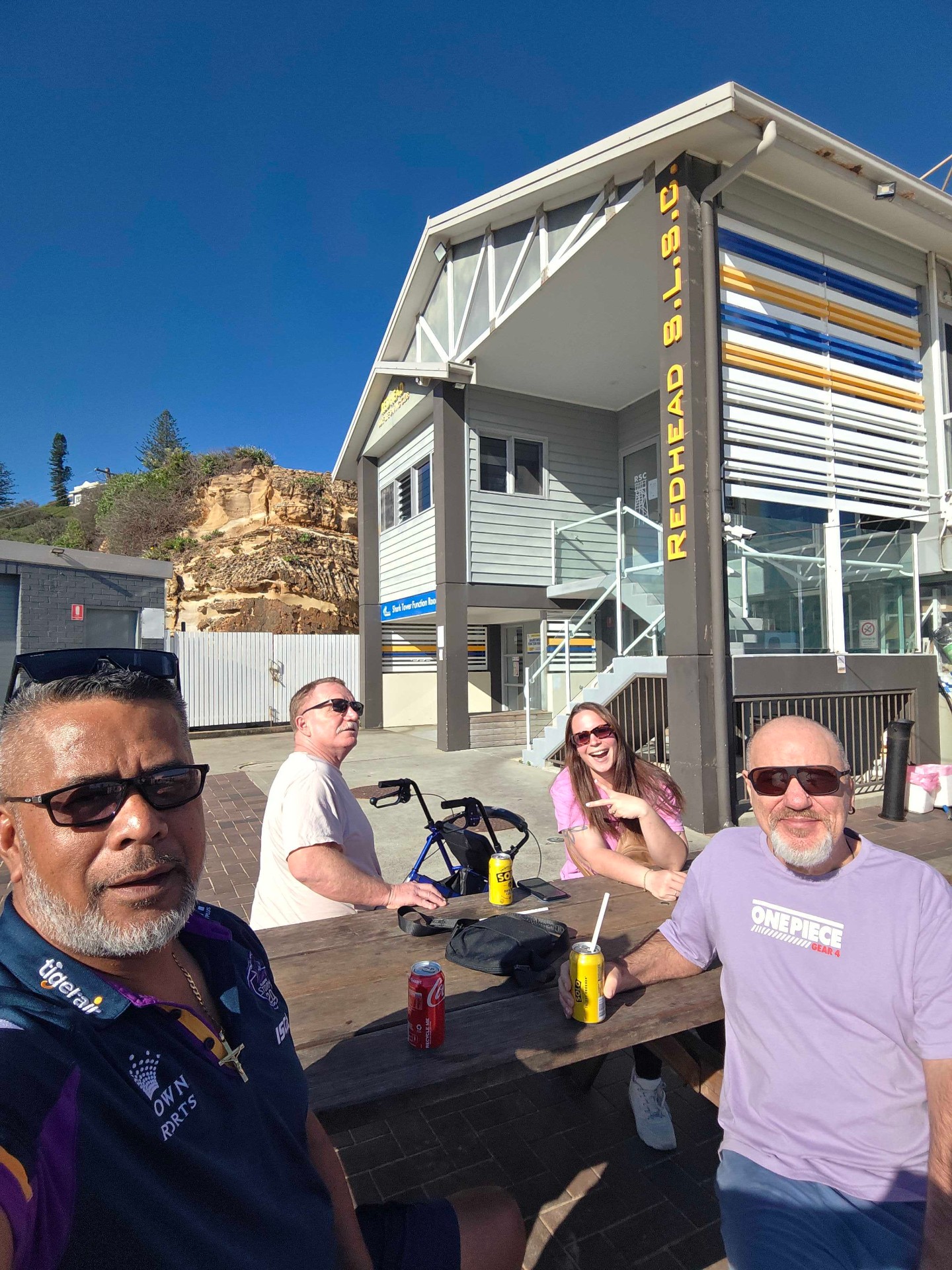 Participants and support workers sharing a sunny afternoon at Redhead Beach